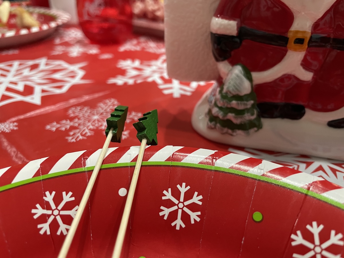 Festive wine and cheese table with Christmas-tree-topped toothpicks